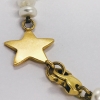 Pulsera de perlas con estrella en oro 18kt.